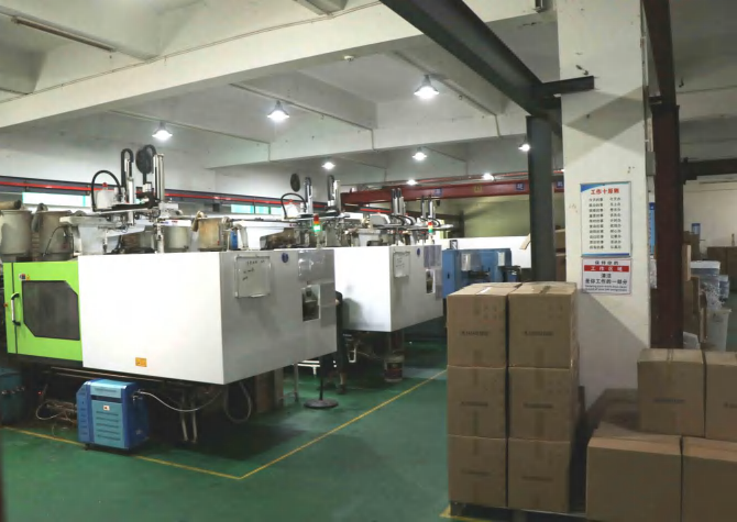 Rows of production machines and stacked cartons inside the factory.